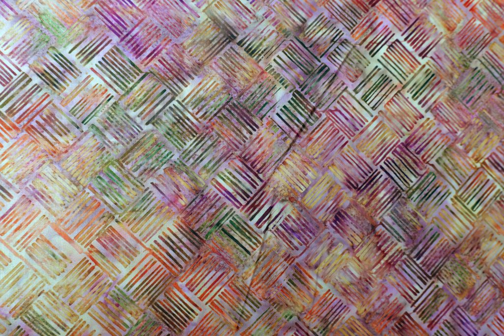 Orange and purple fabric with a line print - Hoffman Fabrics - Bali Batik Handprints – Sku 3343 308