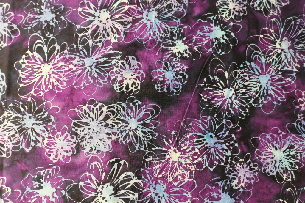 Purple fabric with a light blue floral print - Hoffman Fabrics - Bali Batik Handprints – Sku 3356 507