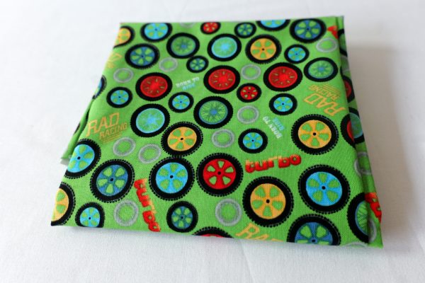 Green fabric with wheels - Northcott Fabric – Rad Riders #3135 by Terry Perry