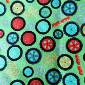 Green fabric with wheels - Northcott Fabric – Rad Riders #3135 by Terry Perry